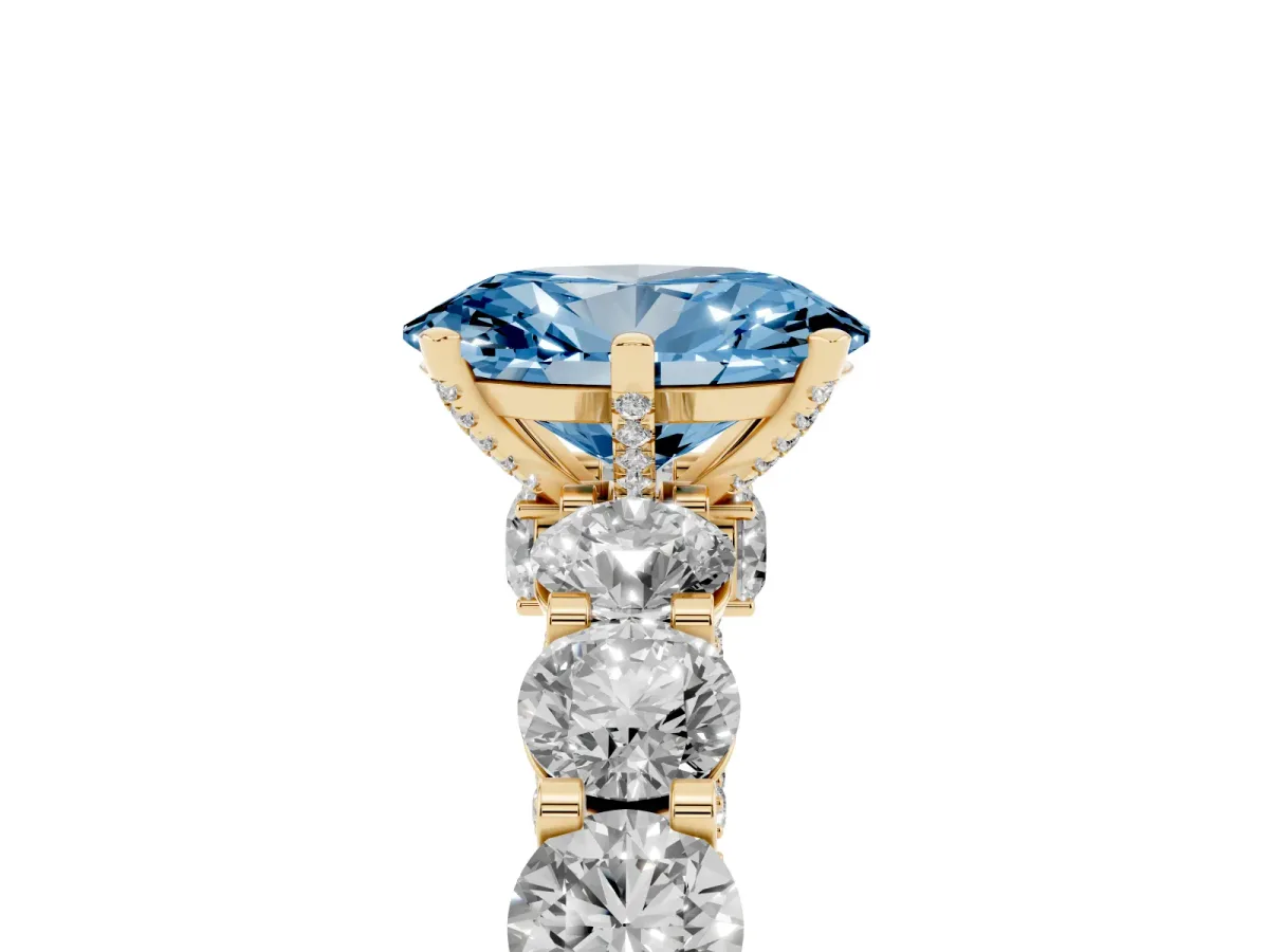 Fancy Blue Oval Cut Diamond Side Stone Engagement Ring with Four-Prong Setting Yellow gold