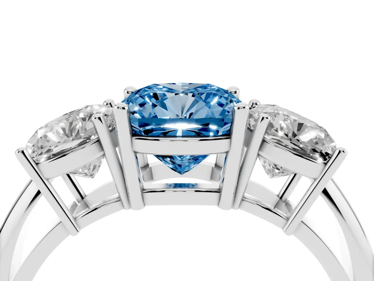 Fancy Blue Three-Stone Cushion Cut Cut Diamond Engagement Ring with Prong Setting on a White Gold Band Platinum