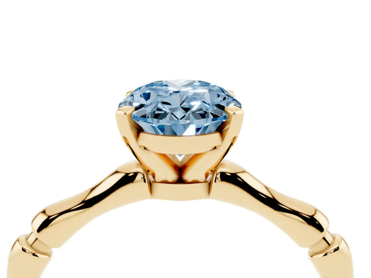 Fancy Blue Oval Cut Solitaire Diamond Ring with Bamboo Band and Four-Prong Setting Yellow gold