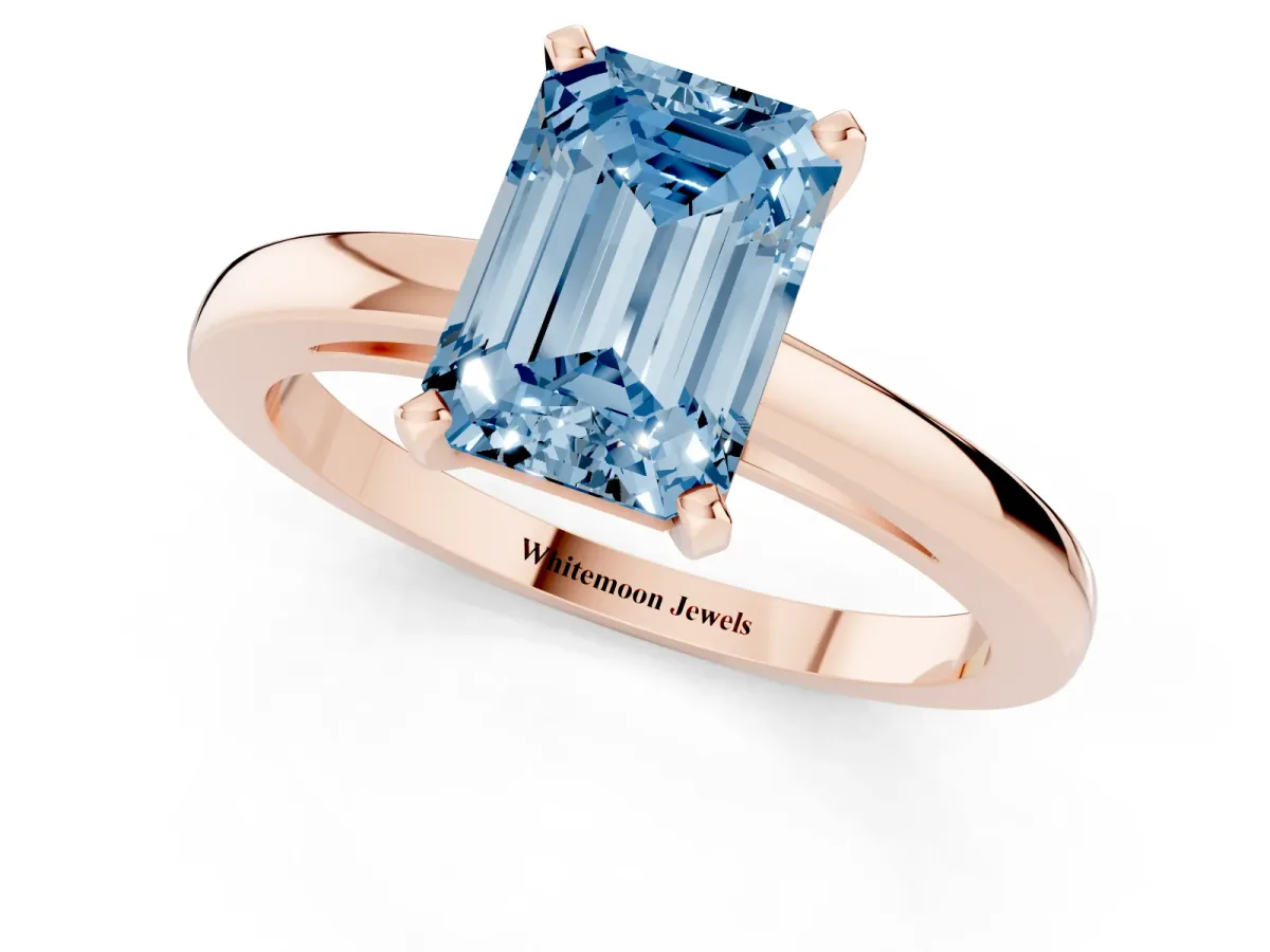 Fancy Blue Emerald Cut Solitaire Diamond Engagement Ring with Four-Prong Setting on a Classic Band Rose gold