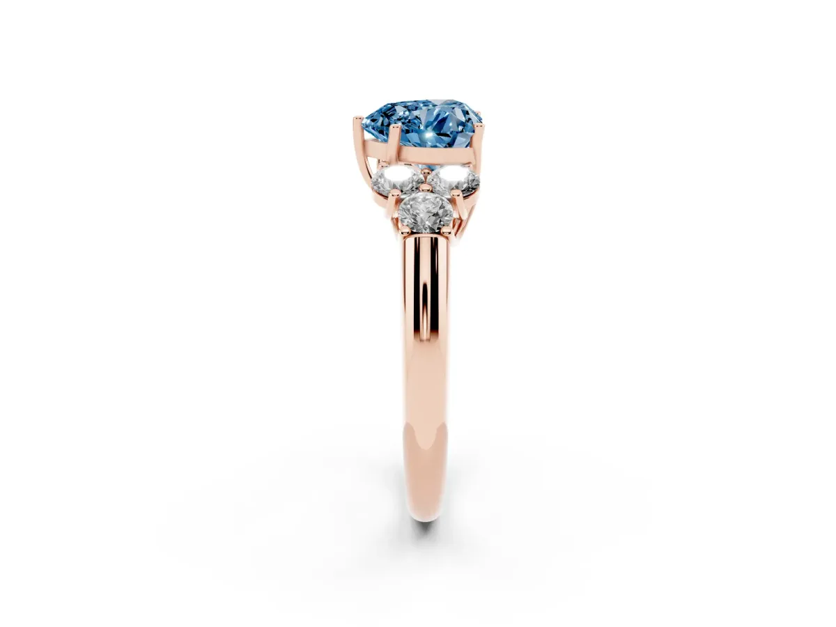 Fancy Blue Heart Cut Cut Diamond Cluster Ring with Round Accent Stones and Prong Setting on a Classic Band Rose gold