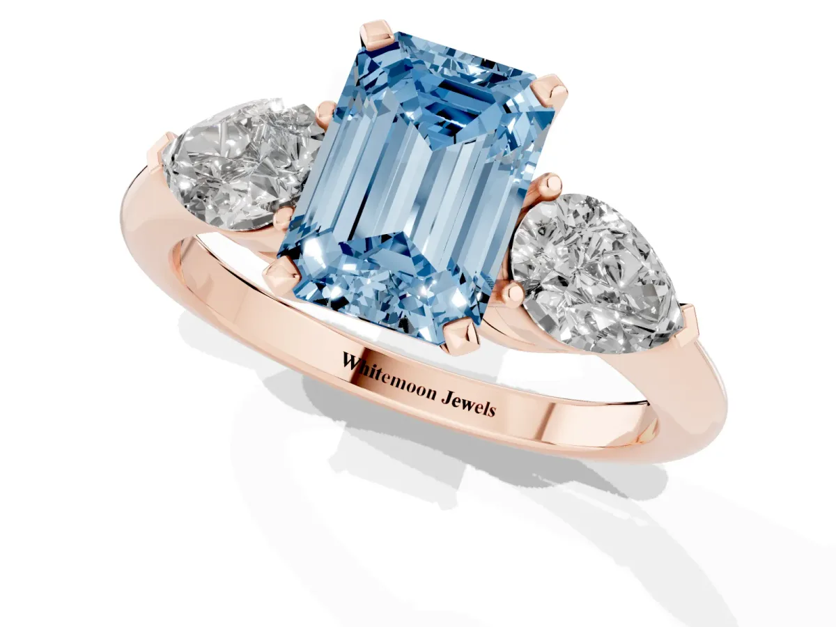 Fancy Blue Three-Stone Emerald Cut Diamond Ring with Pear Side Stones and Four-Prong Setting Rose gold
