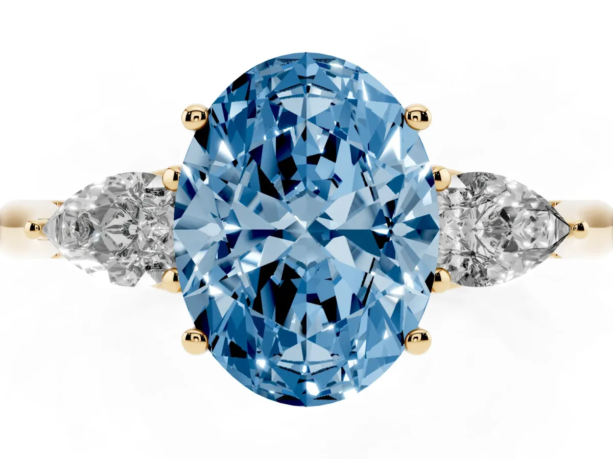 Fancy Blue Three-Stone Oval Cut Brilliant Diamond Solitaire Ring with Tapered Band and Four-Prong Setting Yellow gold