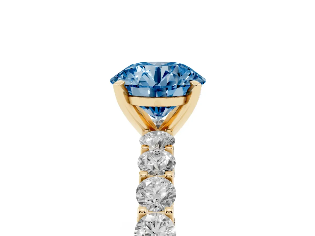 Fancy Blue Round Cut Diamond Solitaire Ring with Shared Prong Pavé Band and Four-Prong Setting Yellow gold