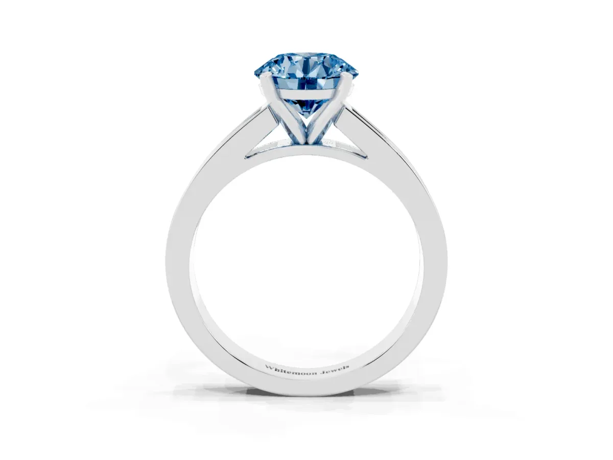 Fancy Blue Round Cut Solitaire Diamond Ring with Channel-Set Band and Four-Prong Setting Platinum