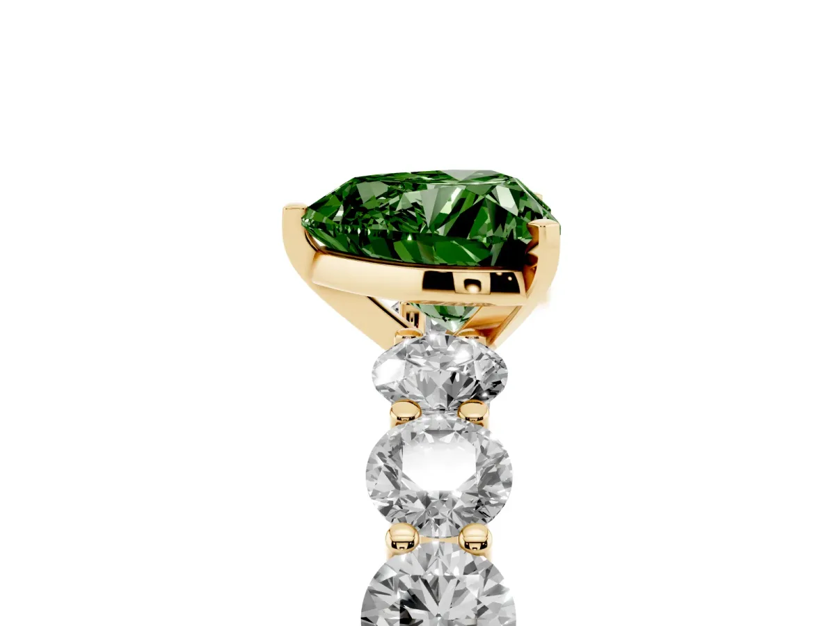 Fancy Green Heart Cut Diamond Prong Setting with Side Stones on a Pave Band Yellow gold