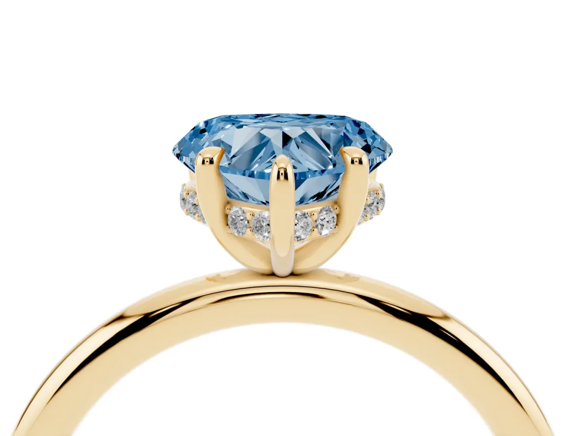 Fancy Blue Heart Cut Diamond Solitaire Ring with Thin Band and Four-Prong Setting Yellow gold