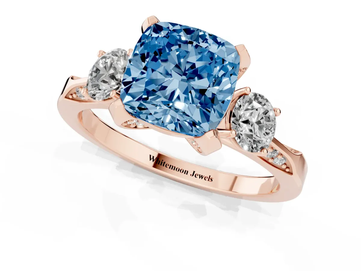 Fancy Blue Cushion Cut Brilliant Three-Stone Diamond Ring with Pavé Band and Four-Prong Setting Rose gold