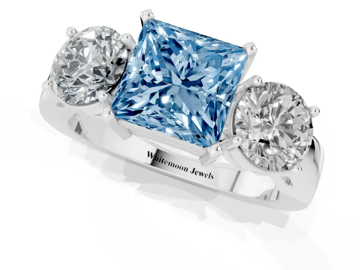 Fancy Blue Three-Stone Princess Cut Diamond Ring with Round Side Stones, Classic Band, and Four-Prong Setting White gold