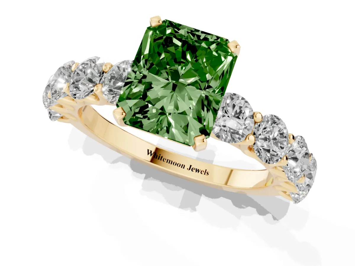 Fancy Green Radiant Cut Diamond Prong Setting with Side Stones on a Pave Band Yellow gold