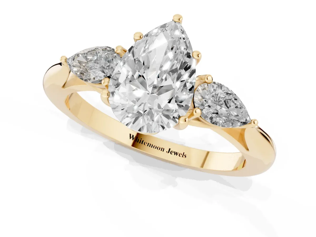 Three-Stone Pear Cut Brilliant Diamond Solitaire Ring with Tapered Band and Four-Prong Setting Yellow gold