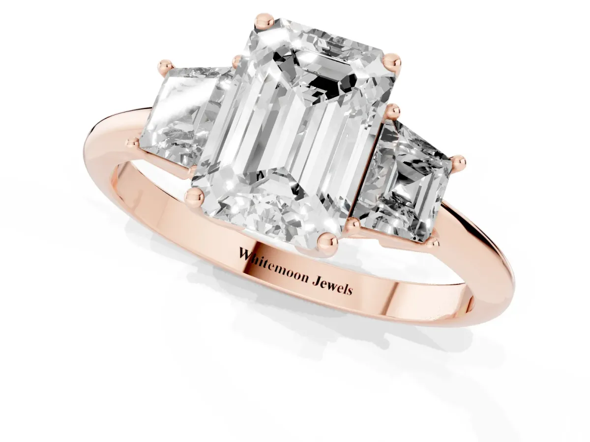 Emerald Cut Diamond Three-Stone Ring with Trapezoid Side Stones and Prong Setting Rose gold