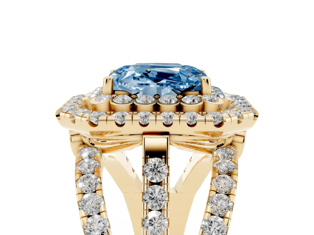 Fancy Blue Emerald Cut Diamond Double Halo Ring with Round Pavé Split Shank and Prong Setting Yellow gold