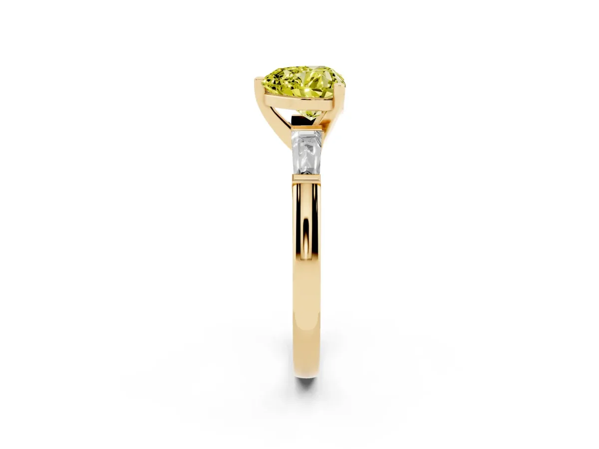 Fancy Yellow Heart Cut Solitaire with Tapered Baguette Side Stones on a Classic Band with Four-Prong Setting Yellow gold