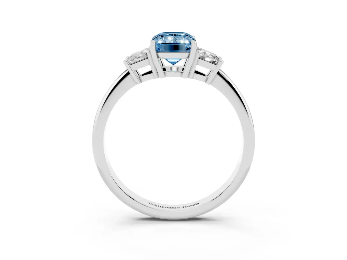 Fancy Blue Emerald Cut Diamond Three-Stone Ring with Trapezoid Side Stones and Prong Setting Platinum