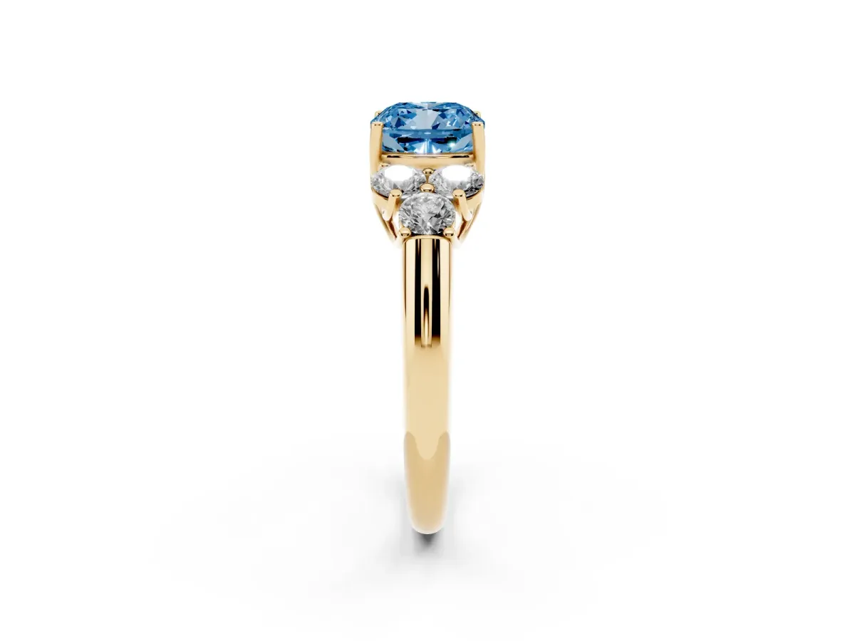Fancy Blue Cushion Cut Cut Diamond Cluster Ring with Round Accent Stones and Prong Setting on a Classic Band Yellow gold