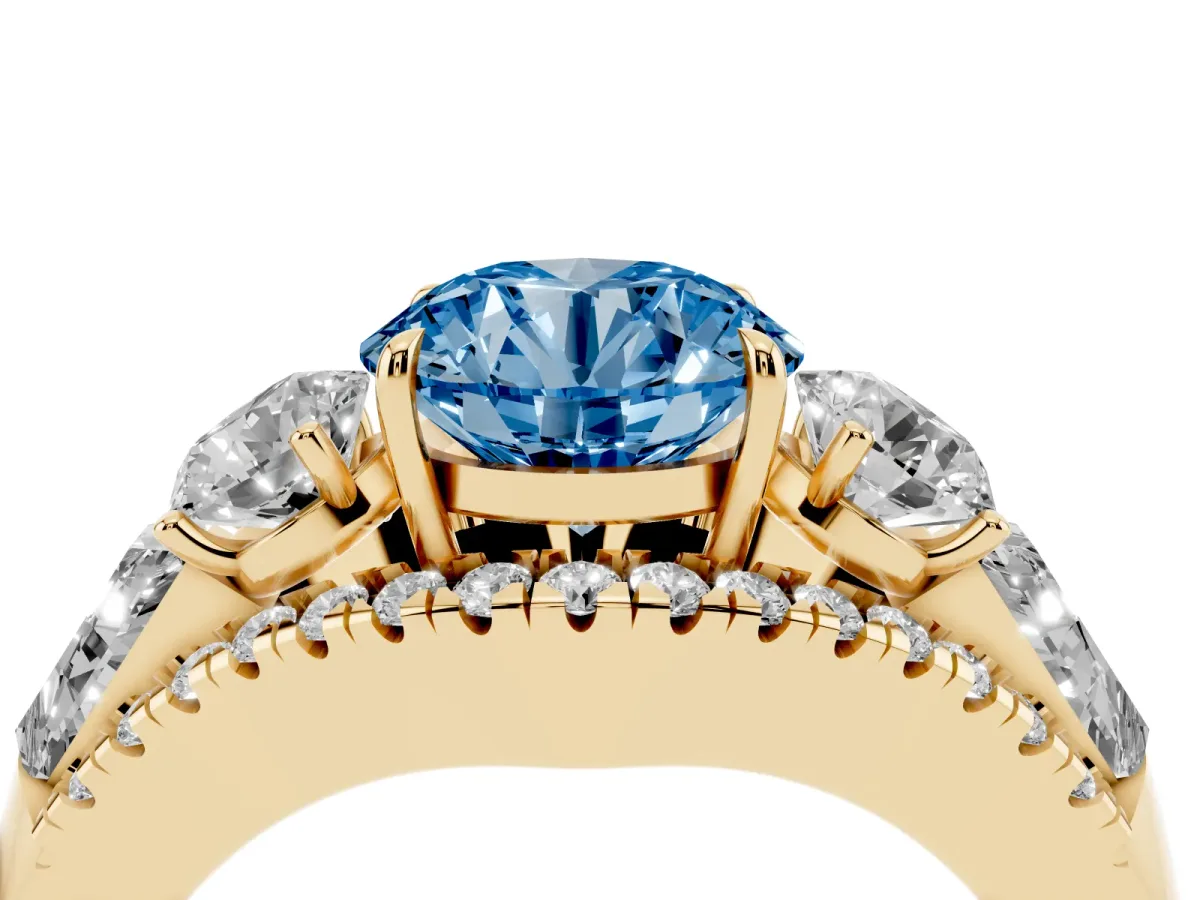 Fancy Blue Three-Stone Round Cut Diamond Engagement Ring with Pave Band and Prong Setting Yellow gold