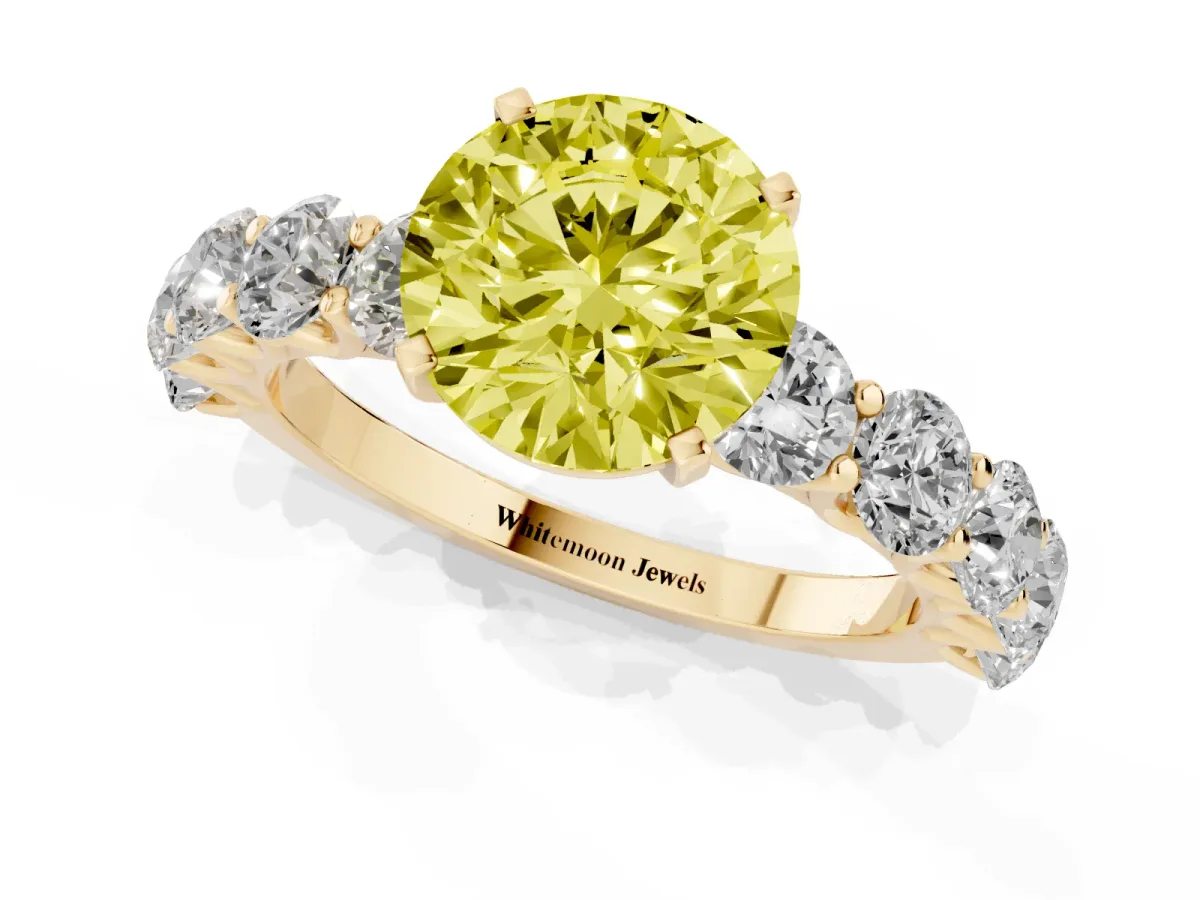 Fancy Yellow Round Cut Diamond Prong Setting with Side Stones on a Pave Band Yellow gold