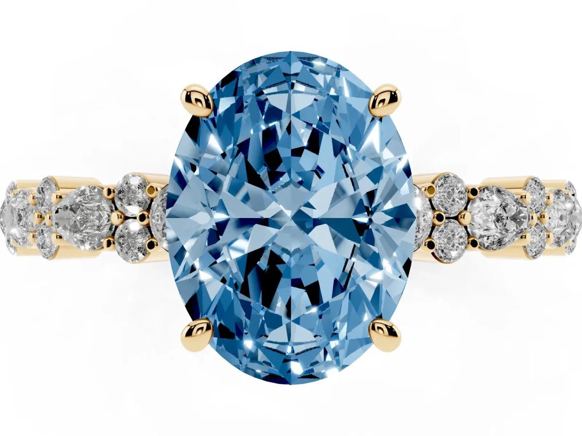 Fancy Blue Oval Cut Diamond Side Stone Solitaire Ring with Round and Four-Prong Setting Yellow gold