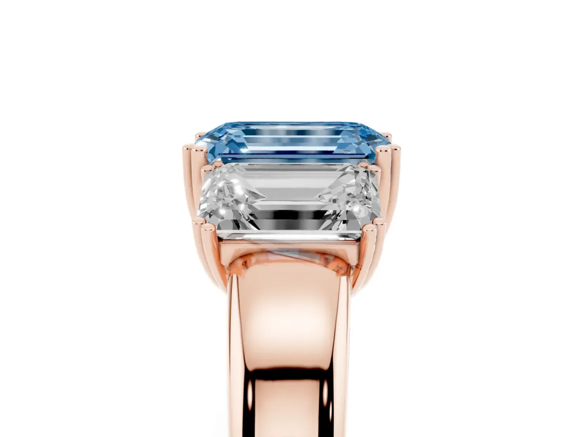 Fancy Blue Three-Stone Emerald Cut Cut Diamond Ring with Channel Set Band and Four-Prong Setting Rose gold