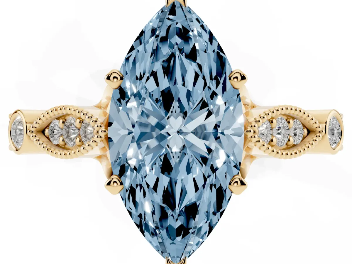 Fancy Blue Marquise Cut Cut Diamond with Milgrain Marquise and Bezel Accents on a Solitaire Band with Prong Setting Yellow gold