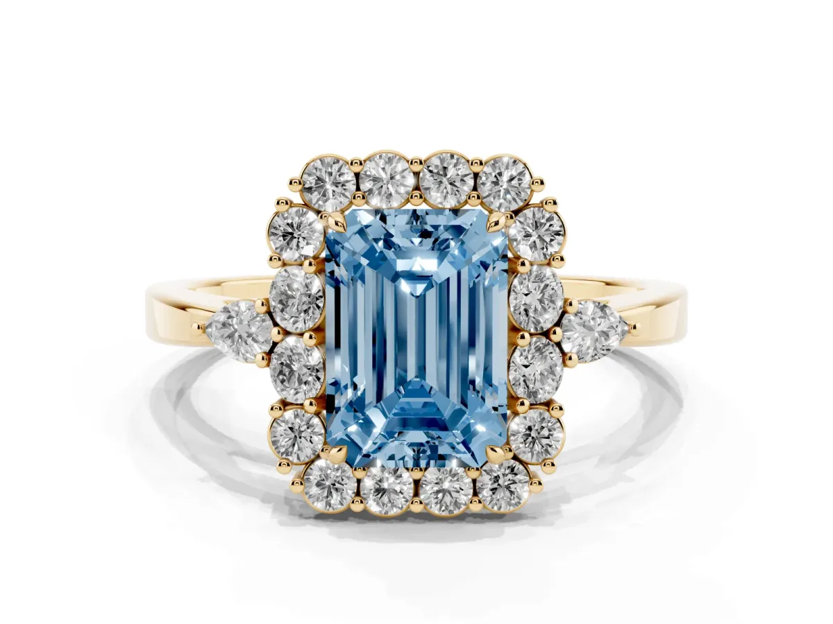 Fancy Blue Emerald Cut Diamond Halo Ring with Pear Side Stones and Prong Setting Yellow gold