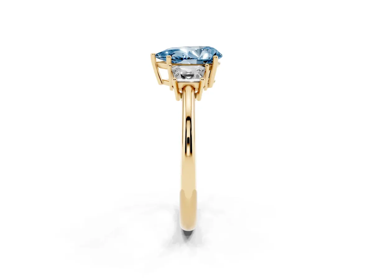 Fancy Blue Pear Cut Diamond Three-Stone Ring with Trapezoid Side Stones and Prong Setting Yellow gold