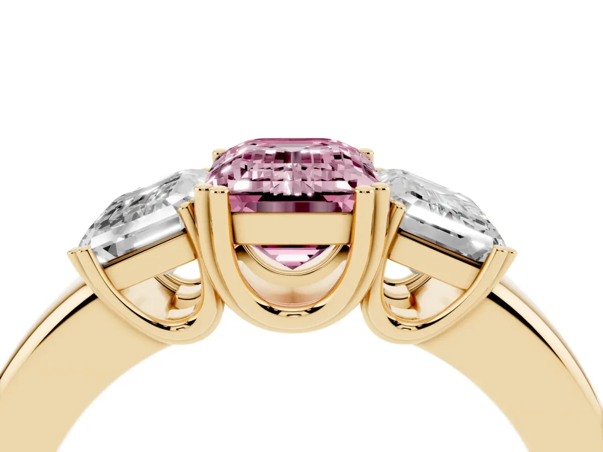 Fancy Pink Three-Stone Emerald Cut Cut Diamond Ring with Channel Set Band and Four-Prong Setting Yellow gold