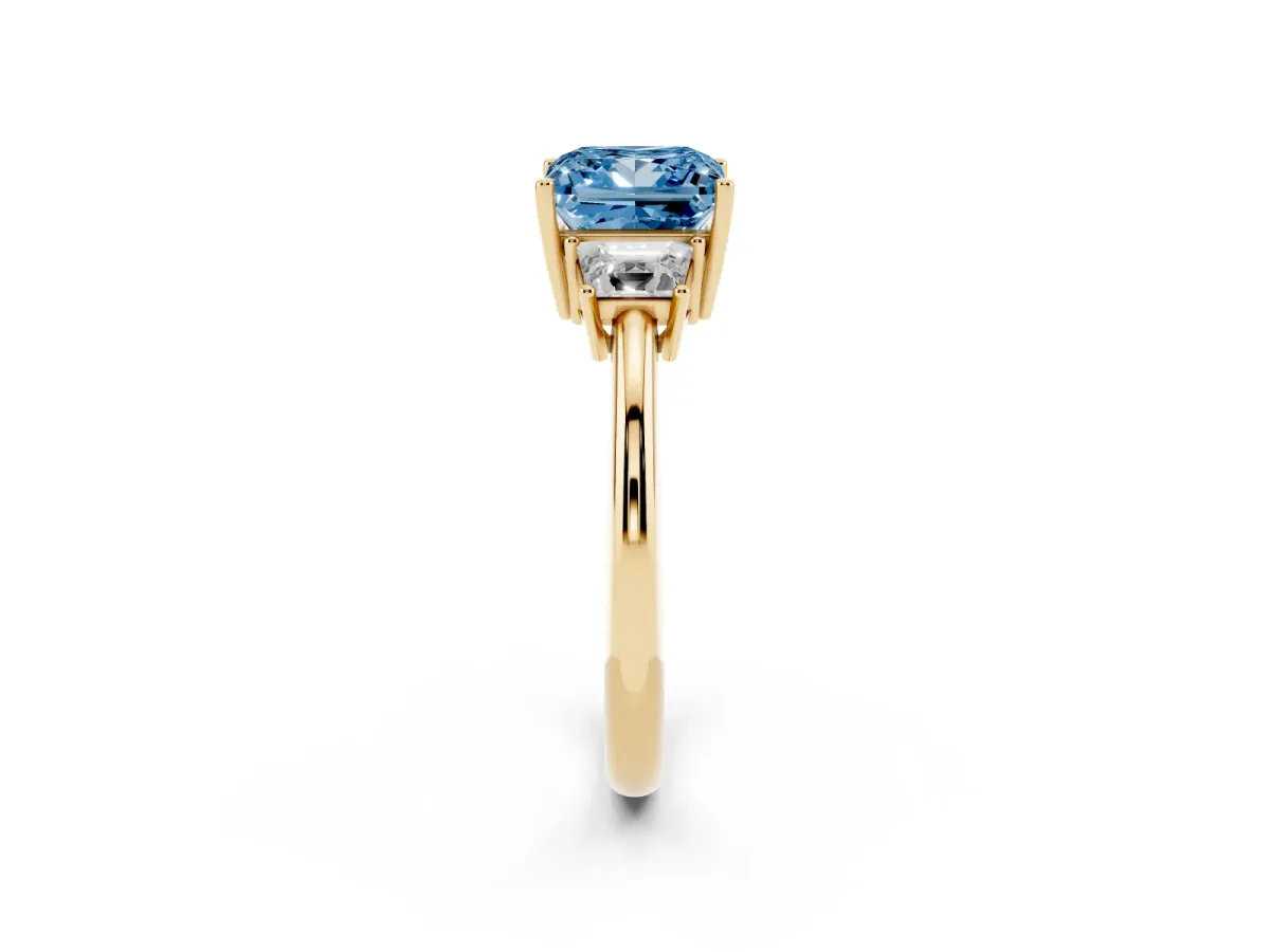 Fancy Blue Princess Cut Diamond Three-Stone Ring with Trapezoid Side Stones and Prong Setting Yellow gold