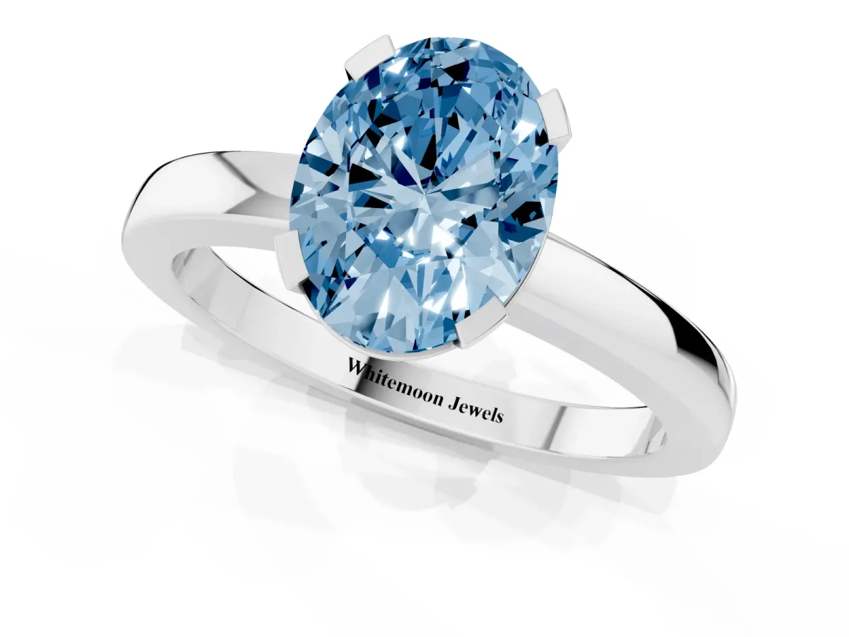 Fancy Blue Oval Cut Cut Solitaire Ring with Four-Prong Setting and Classic Band Silver