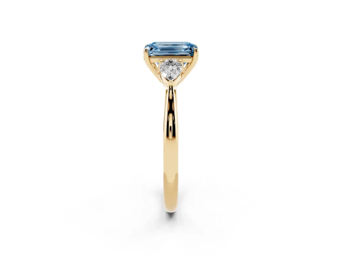Fancy Blue Emerald Cut Diamond Three-Stone Ring with Pear Side Stones and Prong Setting Yellow gold