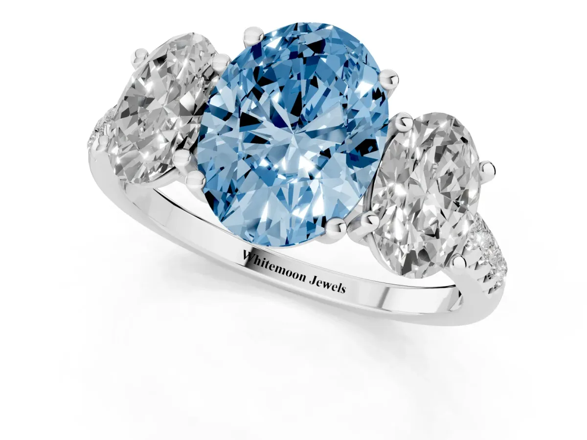 Fancy Blue Three-Stone Oval Cut Diamond Ring with Round Pavé Band and Prong Setting Silver