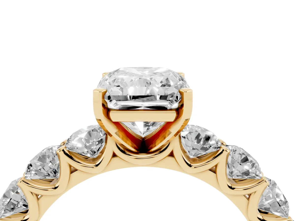 Radiant Cut Diamond Prong Setting with Side Stones on a Pave Band Yellow gold