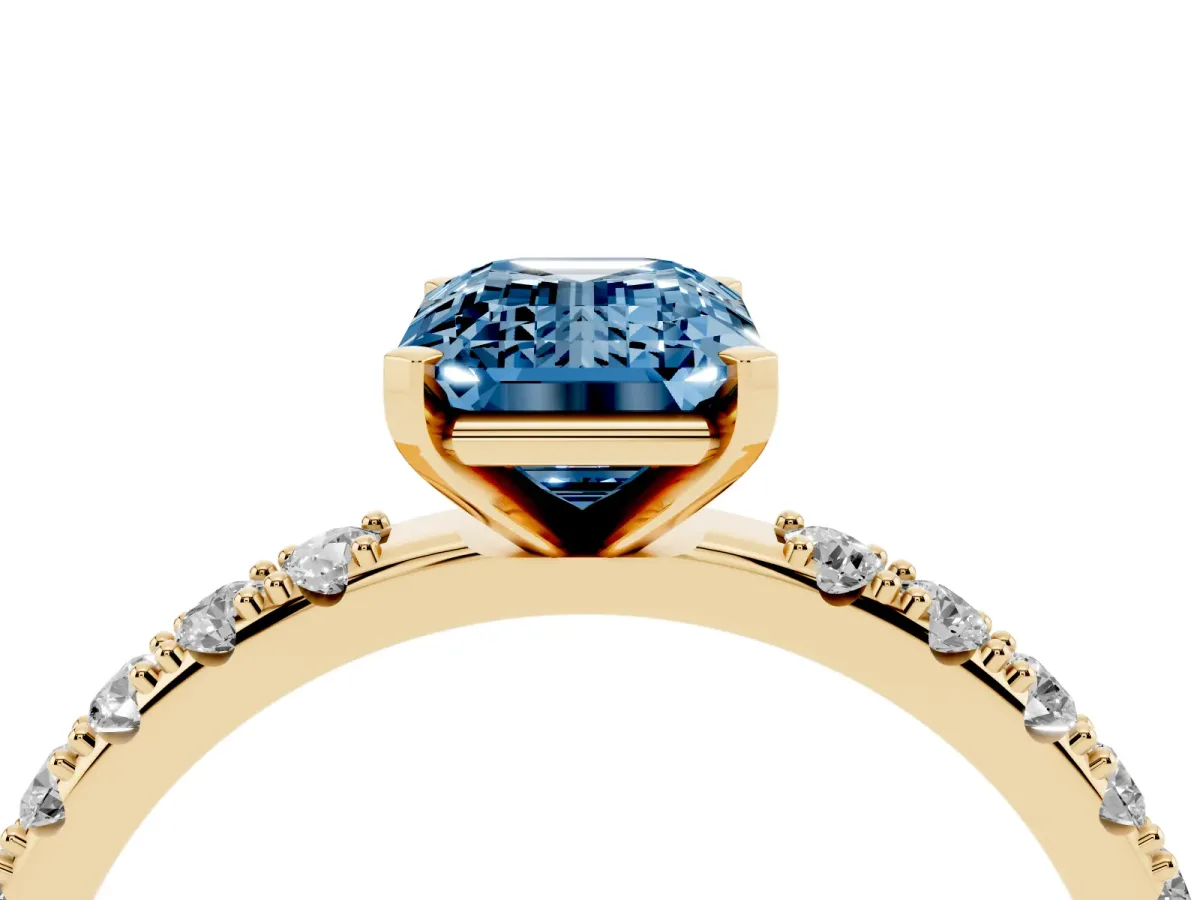 Fancy Blue Emerald Cut Diamond Solitaire Pavé Band with Four-Prong Setting Yellow gold