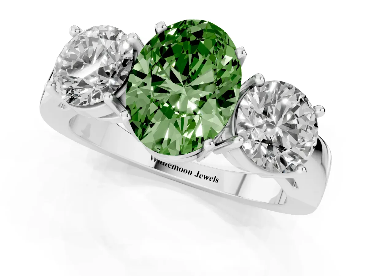Fancy Green Three-Stone Oval Cut Diamond Ring with Round Side Stones, Classic Band, and Four-Prong Setting Silver