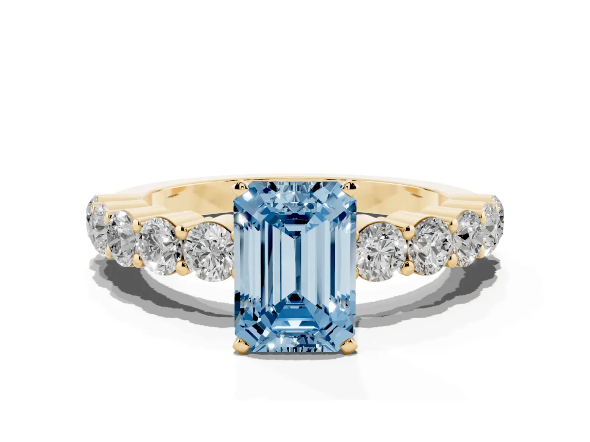Fancy Blue Emerald Cut Diamond Solitaire Ring with Shared Prong Round Side Stones Yellow gold