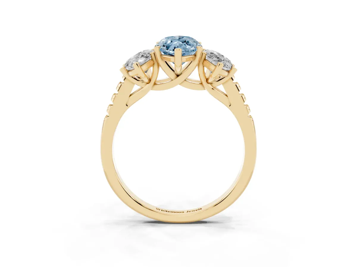 Fancy Blue Three-Stone Marquise Cut Diamond Ring with Round Pavé Band and Prong Setting Yellow gold