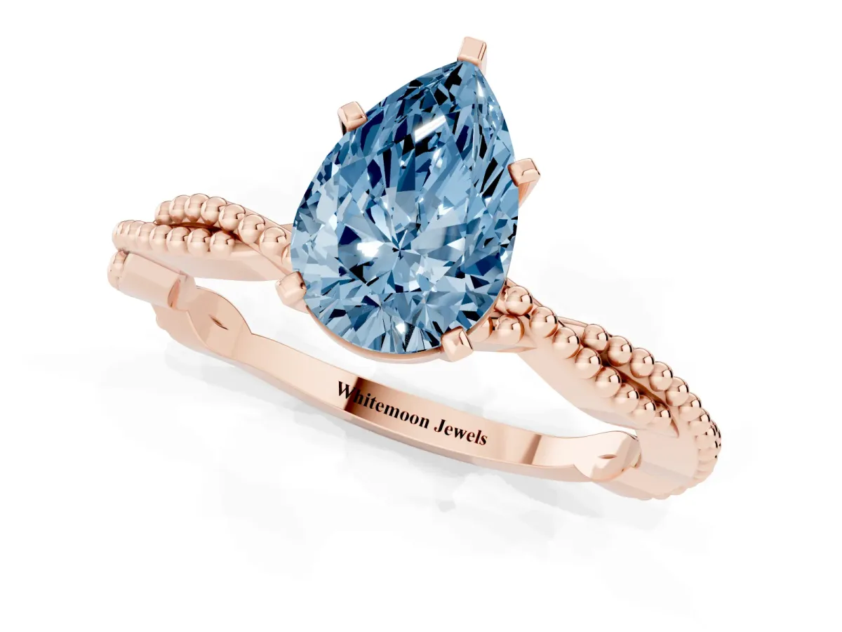 Fancy Blue Pear Cut Solitaire Twisted Band with Bead Prong Setting Rose gold