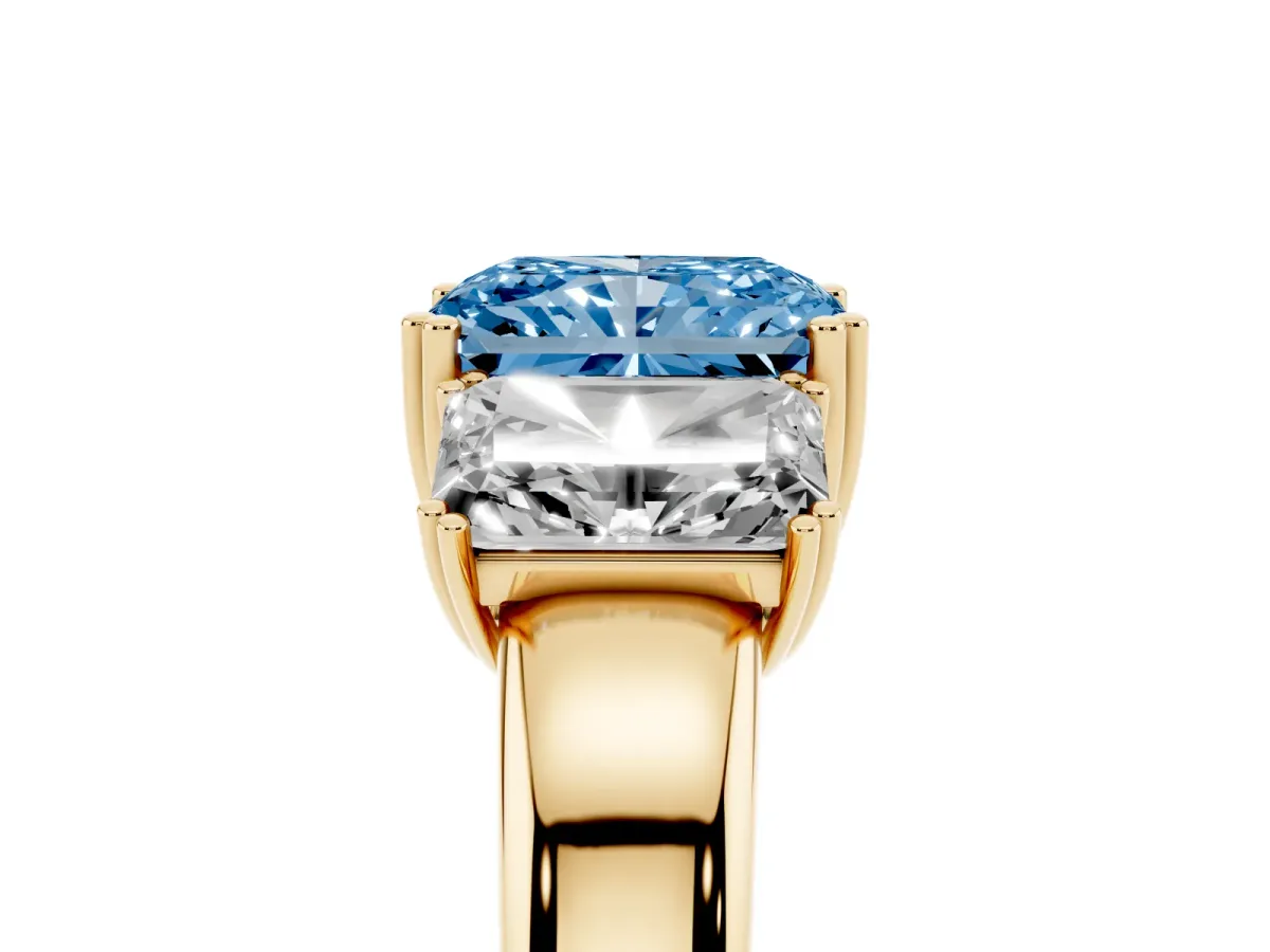 Fancy Blue Three-Stone Radiant Cut Cut Diamond Ring with Channel Set Band and Four-Prong Setting Yellow gold