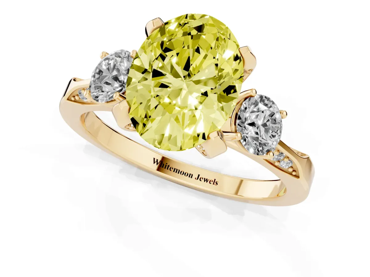 Fancy Yellow Oval Cut Brilliant Three-Stone Diamond Ring with Pavé Band and Four-Prong Setting Yellow gold
