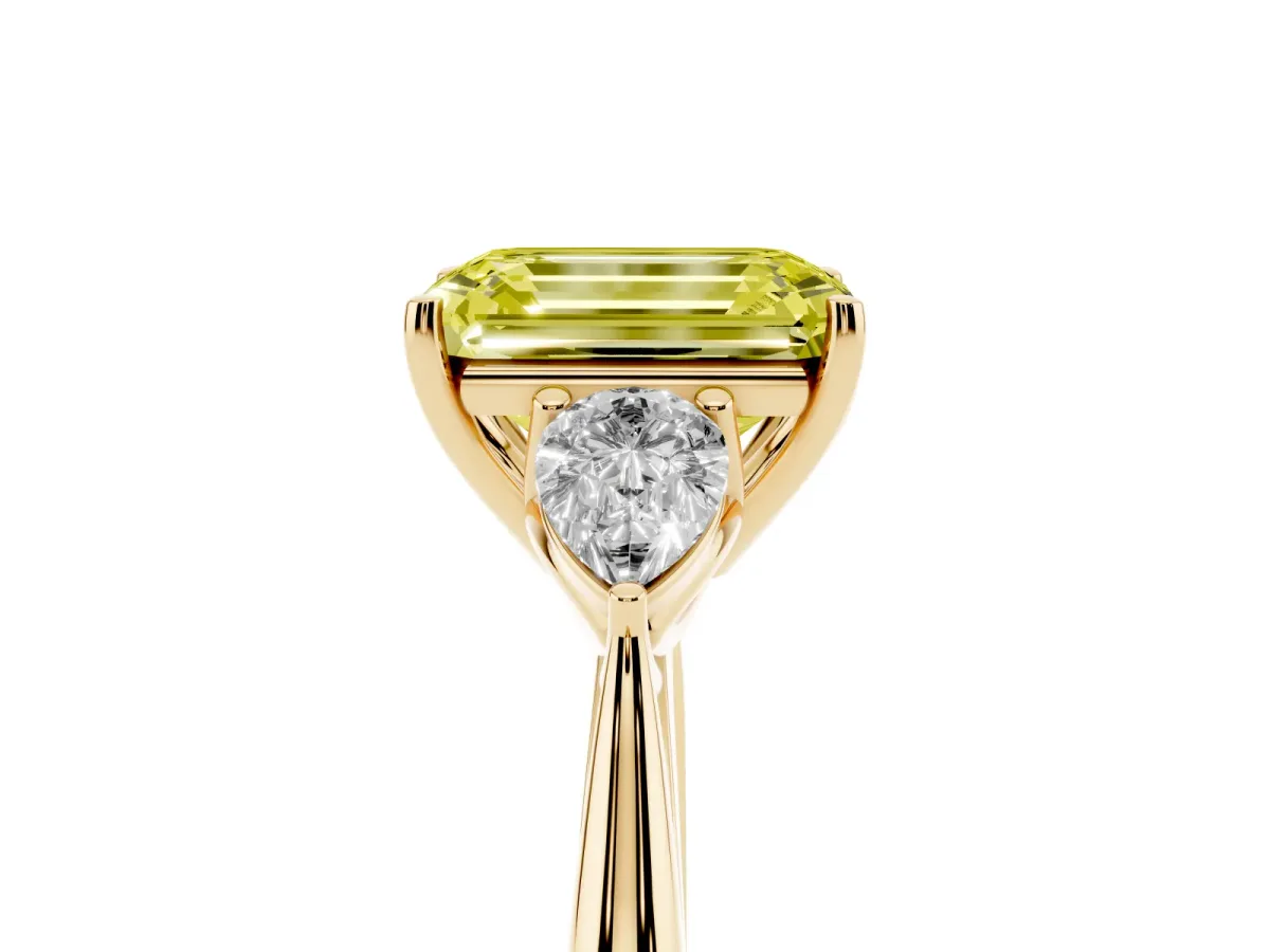 Fancy Yellow Three-Stone Emerald Cut Diamond Ring with Pear Side Stones in Four-Prong Setting Yellow gold