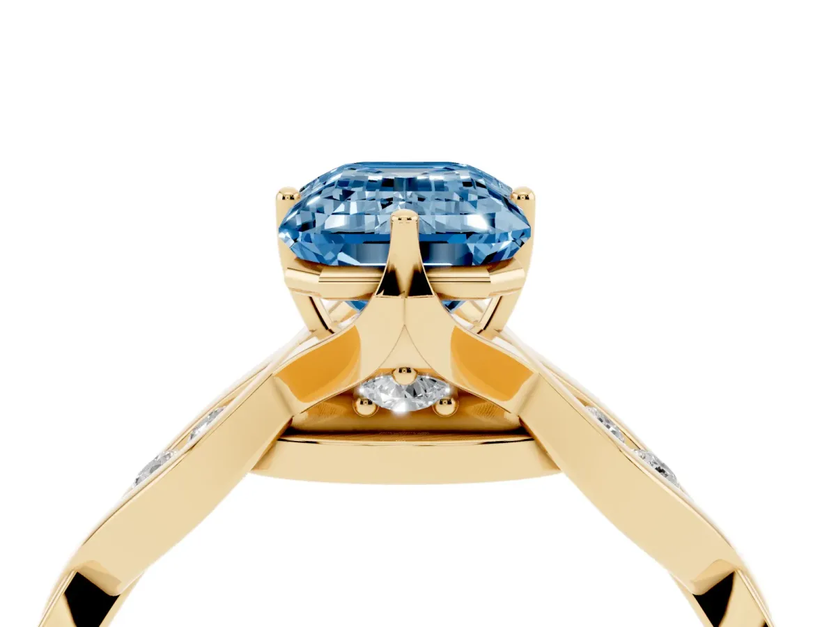 Fancy Blue Emerald Cut Solitaire Twist Band with Leaf Prong Setting Yellow gold
