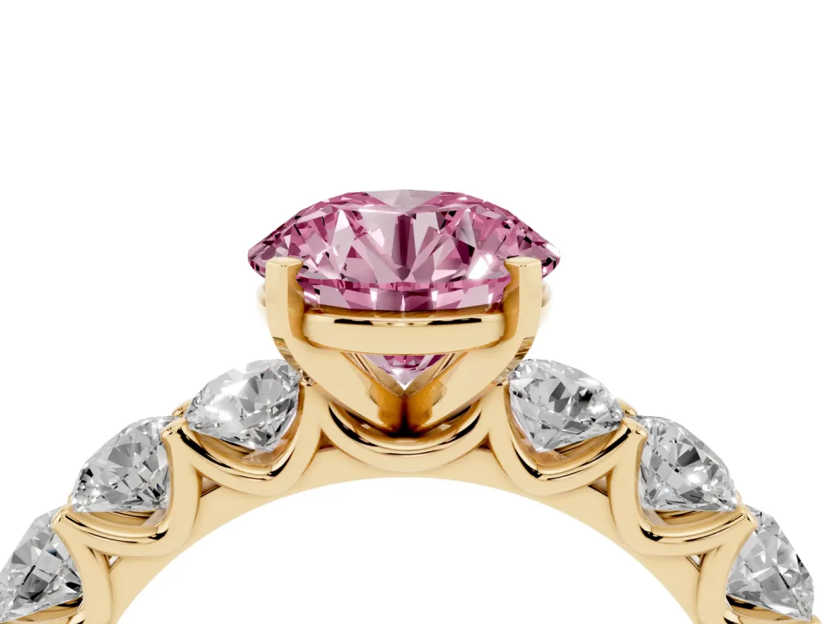 Fancy Pink Round Cut Diamond Prong Setting with Side Stones on a Pave Band Yellow gold