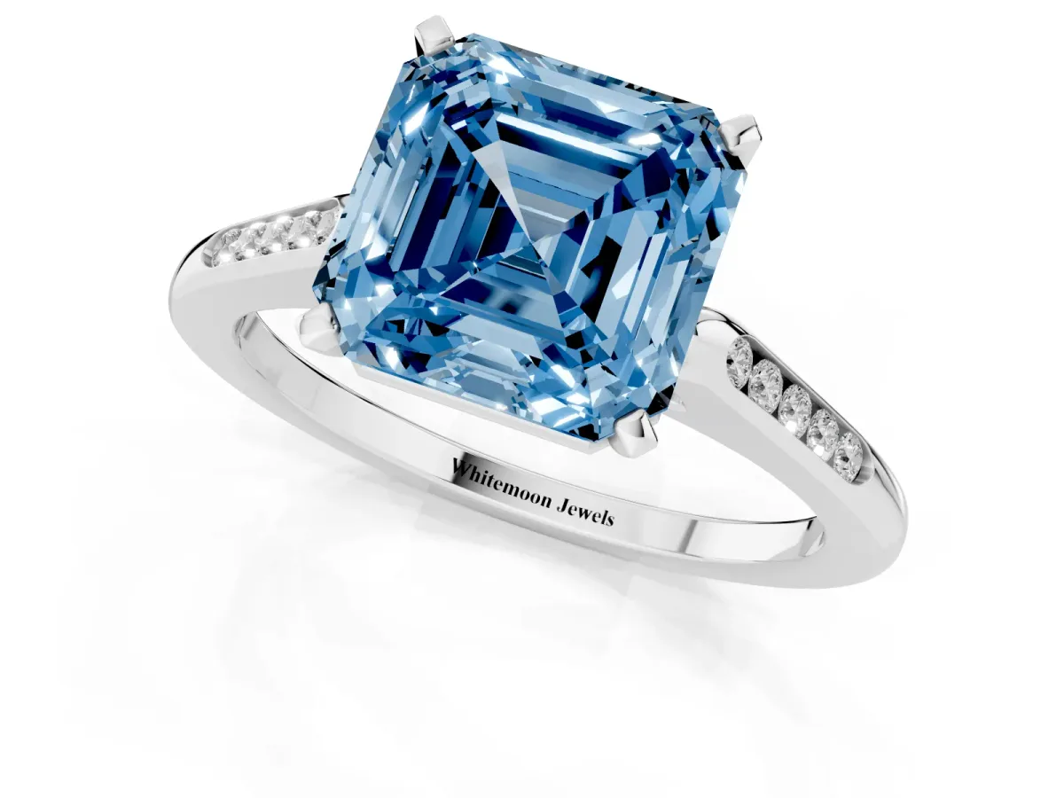 Fancy Blue Asscher Cut Diamond Solitaire Ring with Channel Set Round Band and Prong Setting Silver