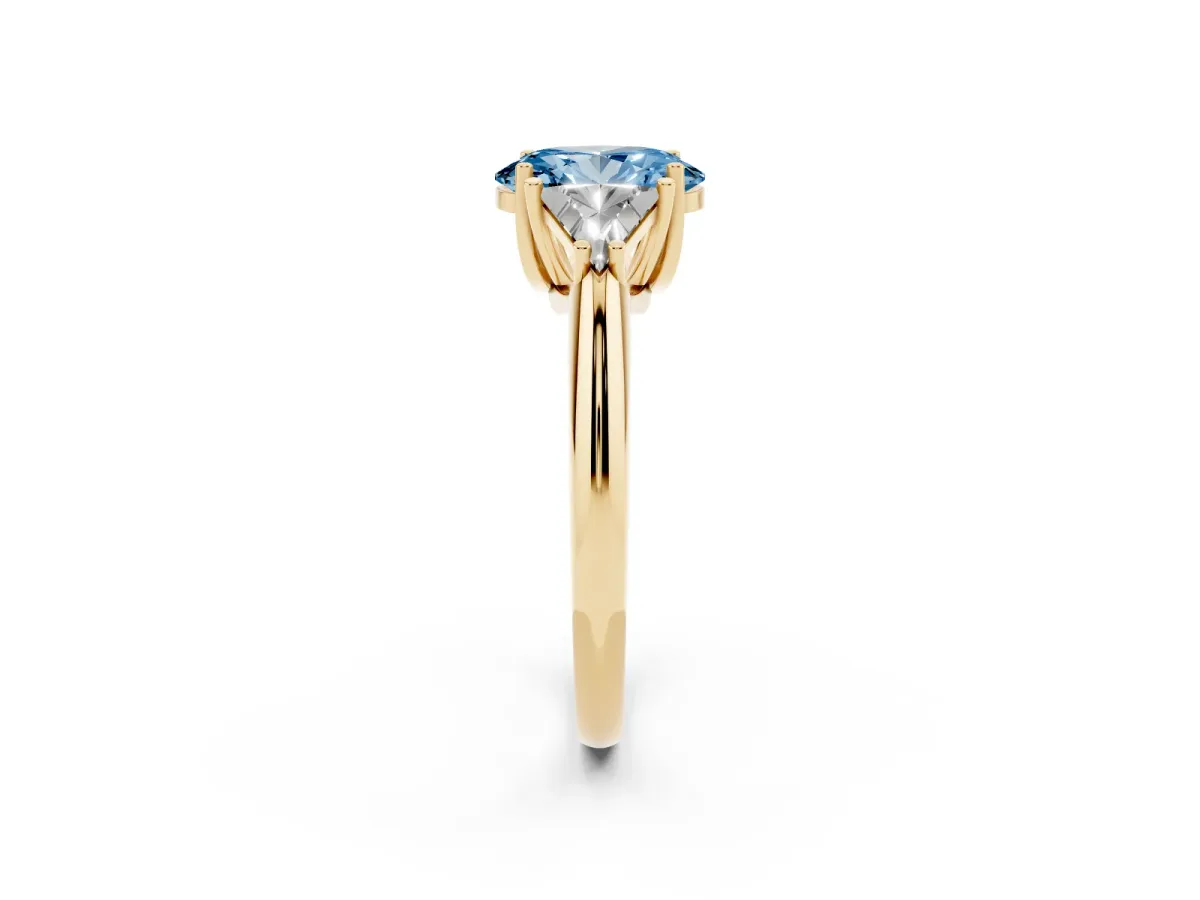 Fancy Blue Three-Stone Oval Cut Diamond Engagement Ring with Trillion Side Stones and Prong Setting Yellow gold
