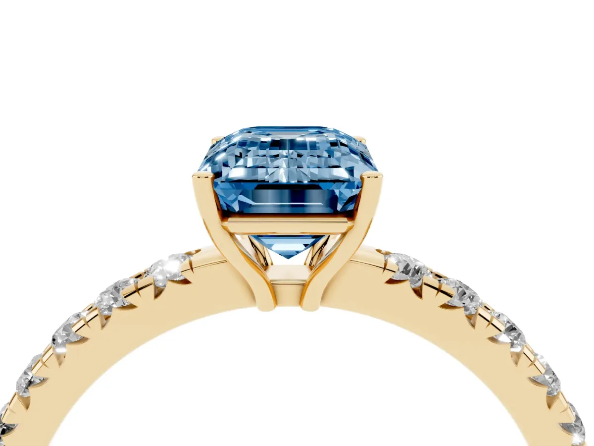 Fancy Blue Emerald Cut Diamond Pavé Solitaire Engagement Ring with Four-Prong Setting Yellow gold