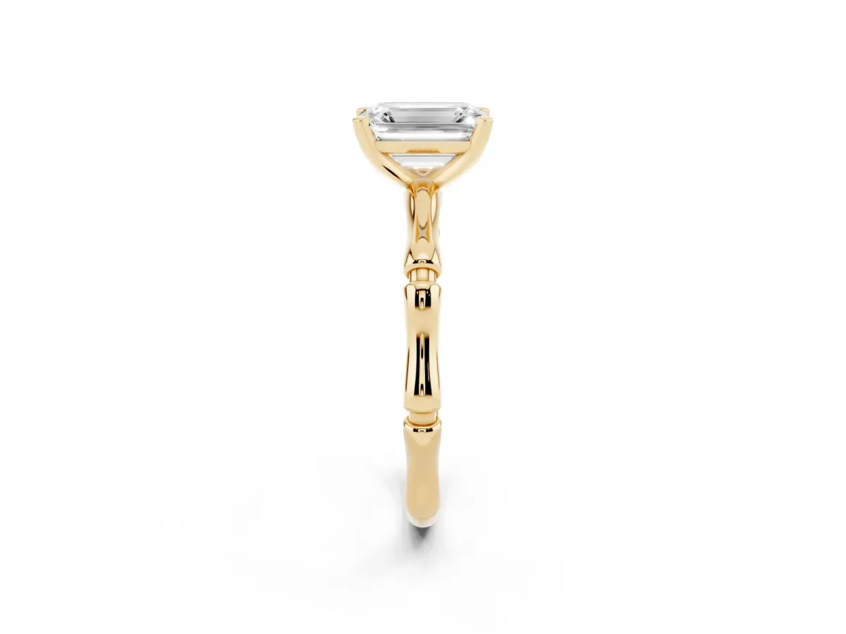Emerald Cut Solitaire Diamond Ring with Bamboo Band and Four-Prong Setting Yellow gold