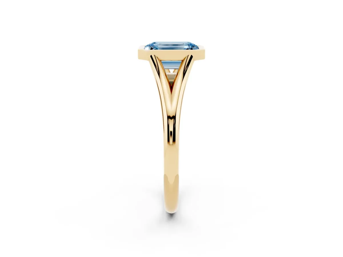 Fancy Blue Bezel Set Emerald Cut Cut Solitaire Ring with Tapered Band Yellow gold
