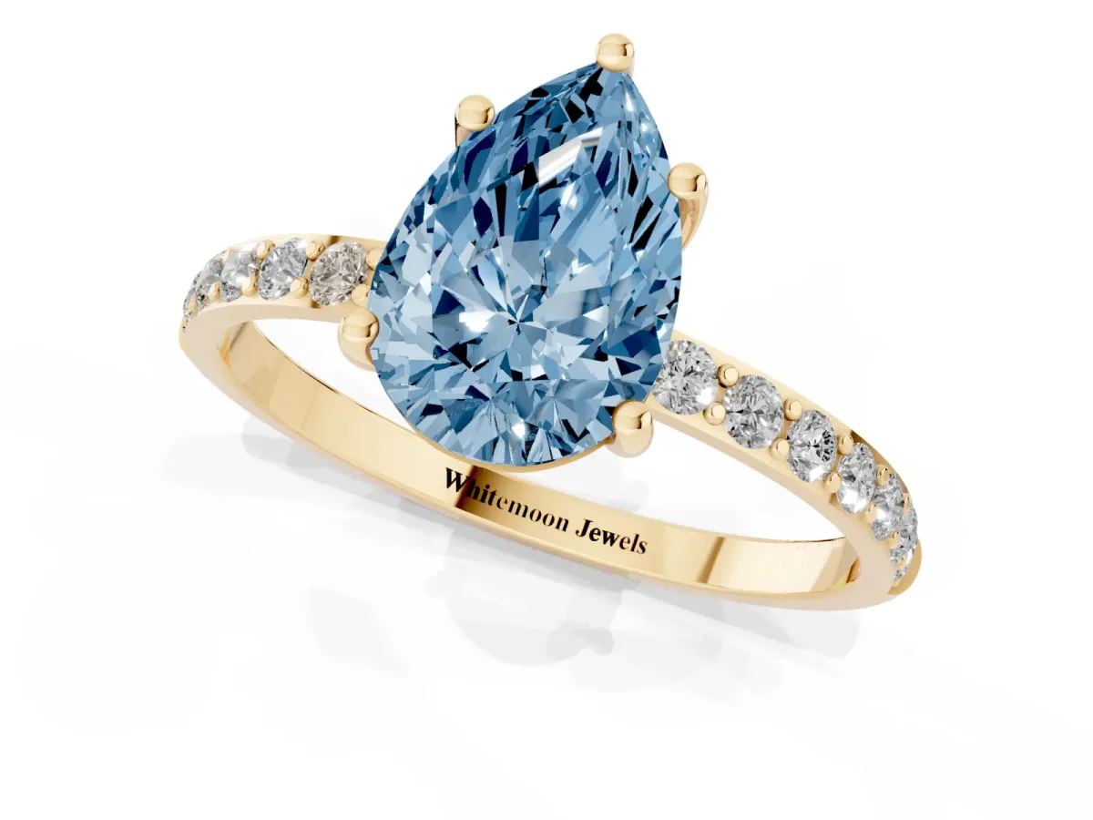 Fancy Blue Pear Cut Diamond Solitaire Ring with Round Pavé Shoulders and Prong Setting Yellow gold