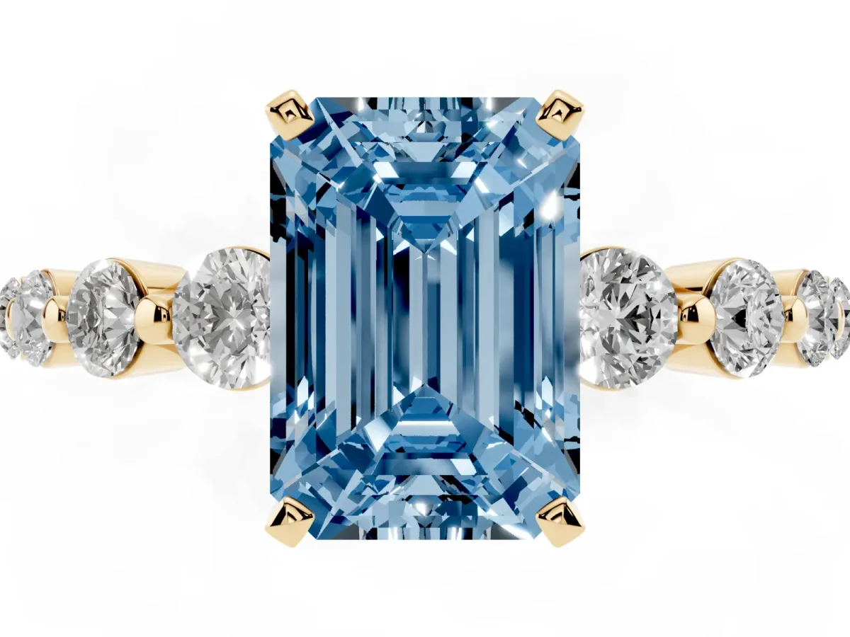 Fancy Blue Emerald Cut Solitaire Diamond Ring with Pave Band and Four-Prong Setting Yellow gold